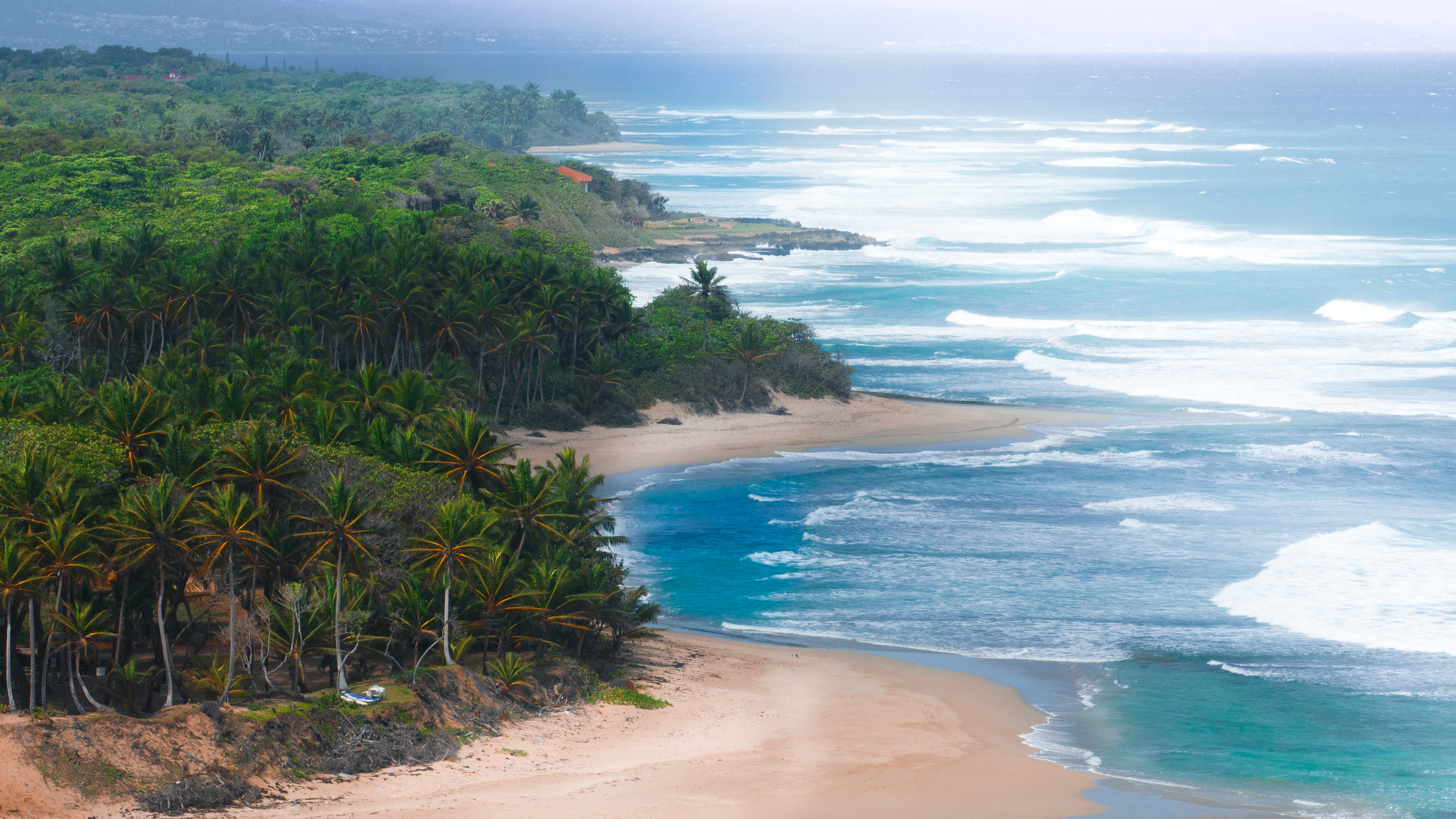 Heavy groundswell rolling into the north coast, the shoreline intact